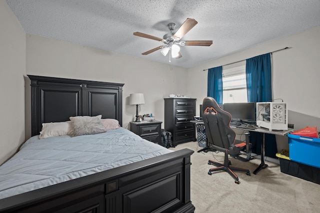 carpeted bedroom featuring ceiling fan and a textured ceiling