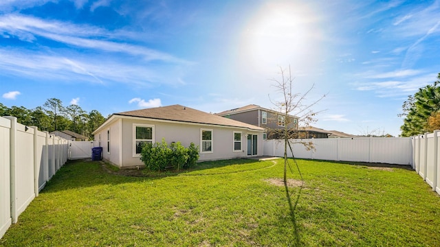 back of property featuring a lawn