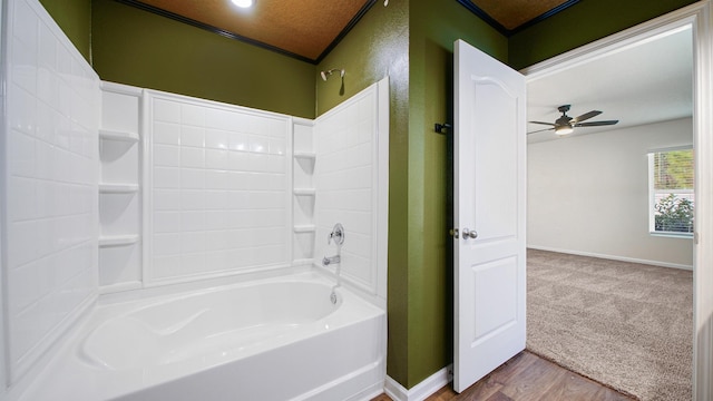 bathroom with shower / bathing tub combination, ceiling fan, and hardwood / wood-style flooring