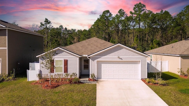 ranch-style house with a garage and a yard