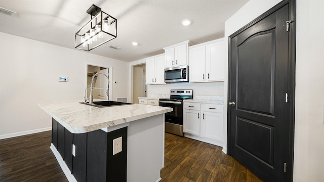 kitchen with sink, pendant lighting, a center island with sink, white cabinets, and appliances with stainless steel finishes