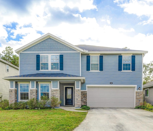 view of front of home with a front lawn and a garage