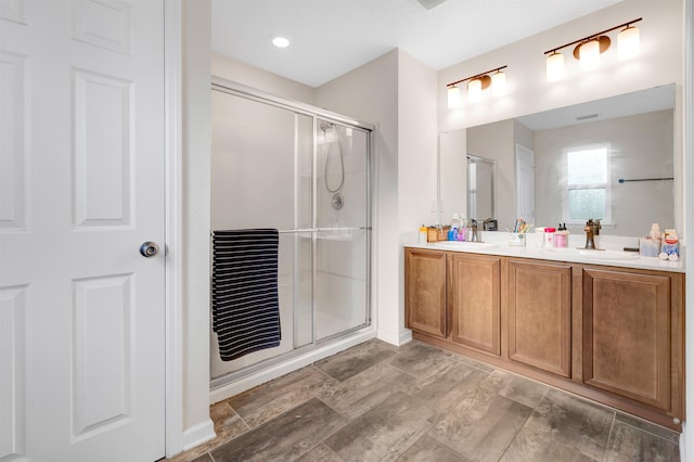 bathroom featuring vanity and a shower with door