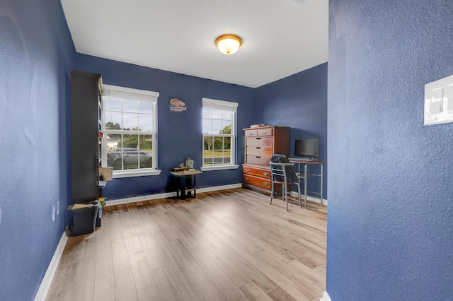 miscellaneous room with hardwood / wood-style floors and a textured ceiling