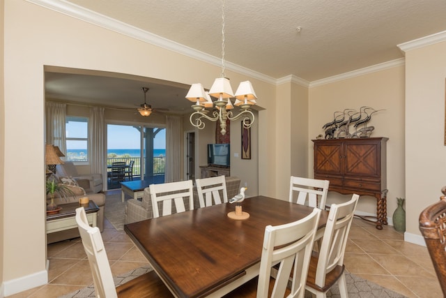 tiled dining space with crown molding, ceiling fan with notable chandelier, and a textured ceiling