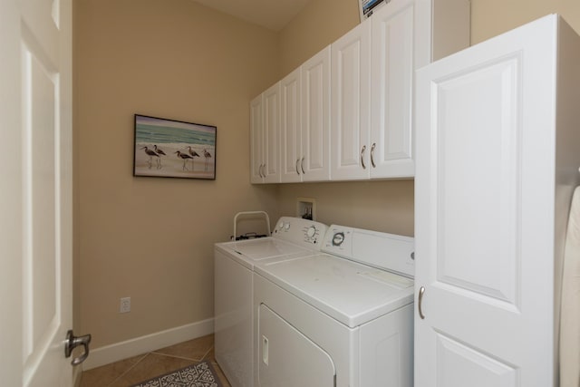 laundry room featuring cabinets, tile patterned floors, and washer and dryer