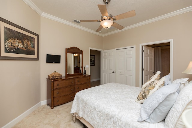 bedroom with ornamental molding, light colored carpet, ceiling fan, and a closet