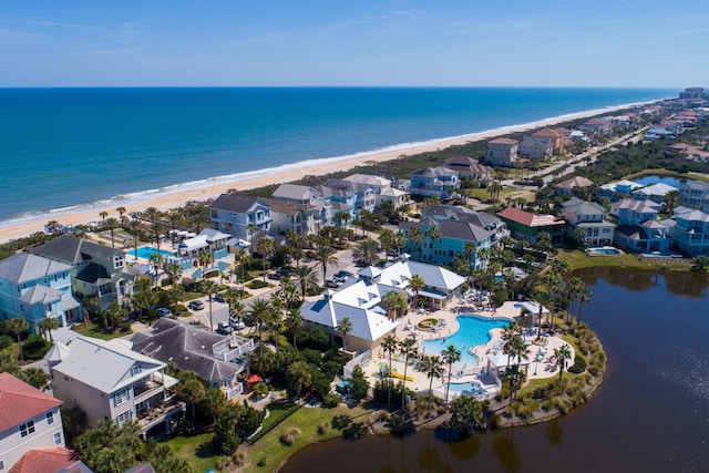 birds eye view of property with a water view and a view of the beach