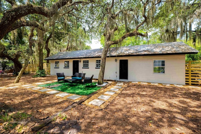 rear view of property with outdoor lounge area