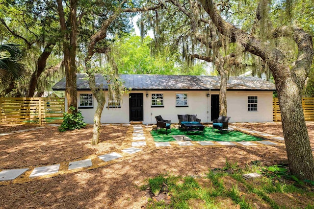 rear view of property featuring an outdoor living space