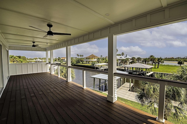 wooden deck featuring ceiling fan and a water view