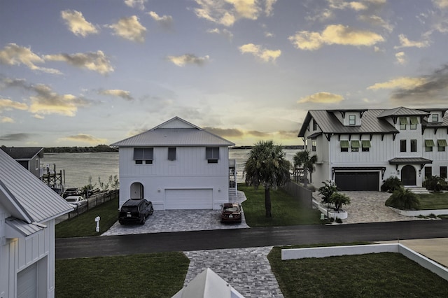 exterior space featuring a water view and a garage