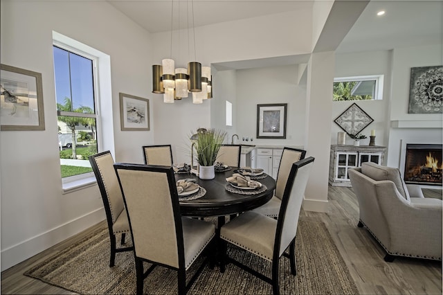 dining space with a chandelier, hardwood / wood-style floors, and a healthy amount of sunlight