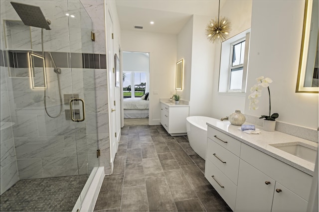 bathroom with vanity, a healthy amount of sunlight, and an enclosed shower