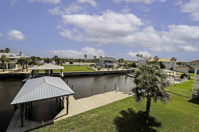 view of dock featuring a lawn and a water view