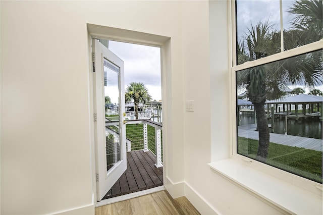 entryway with a water view and hardwood / wood-style flooring