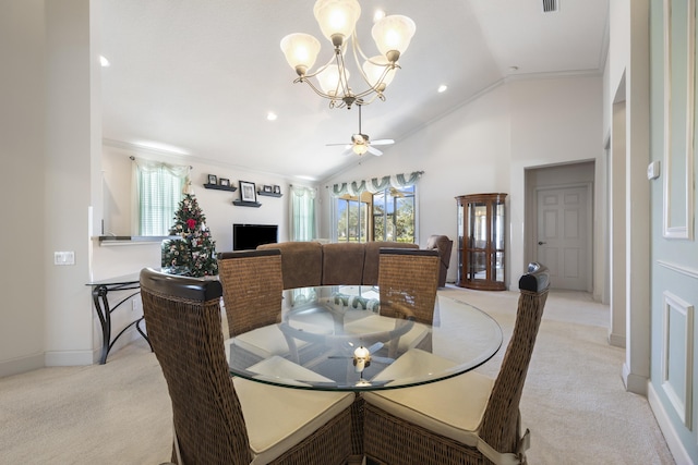 dining room featuring light carpet, ceiling fan with notable chandelier, high vaulted ceiling, and ornamental molding