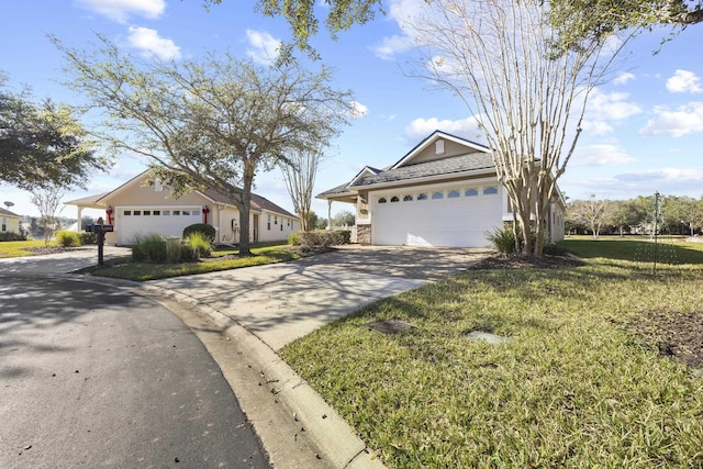 ranch-style home featuring a garage and a front lawn