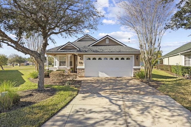 view of front of house featuring a porch, a garage, and a front lawn