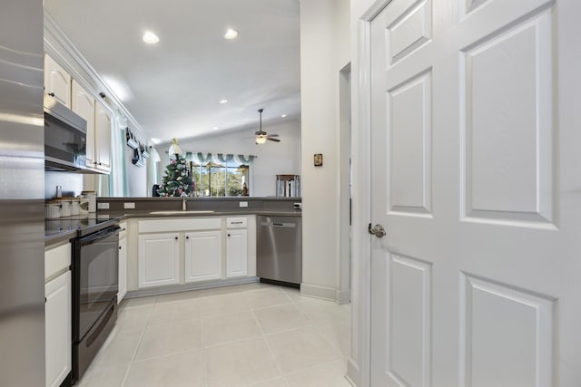 kitchen featuring vaulted ceiling, ceiling fan, white cabinetry, kitchen peninsula, and stainless steel appliances