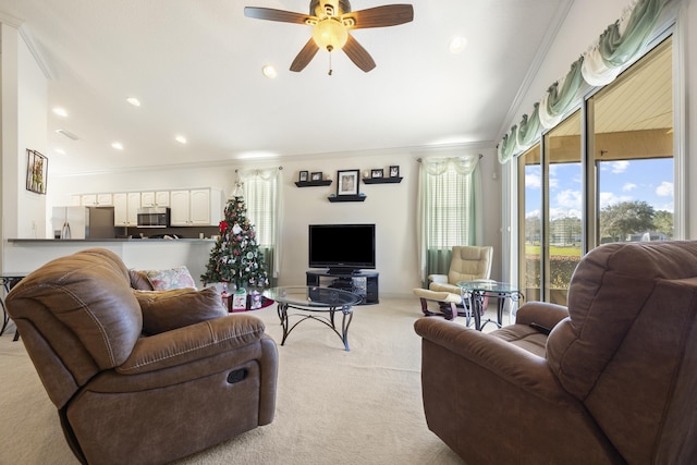 carpeted living room with ceiling fan and ornamental molding