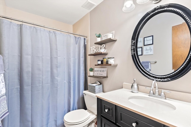 bathroom featuring vanity, curtained shower, and toilet