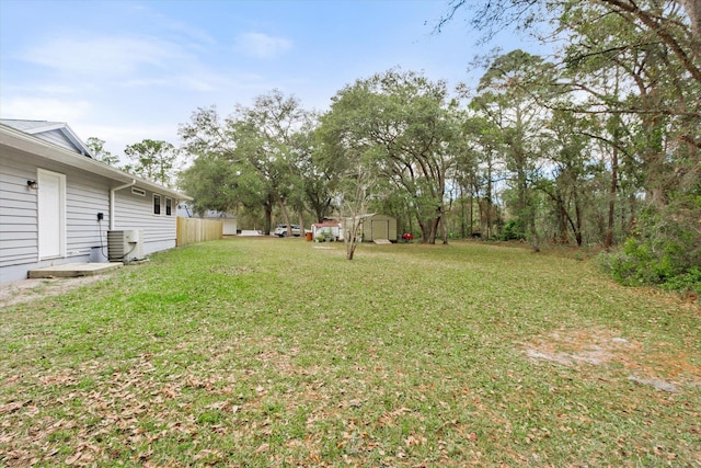 view of yard featuring cooling unit and a storage shed