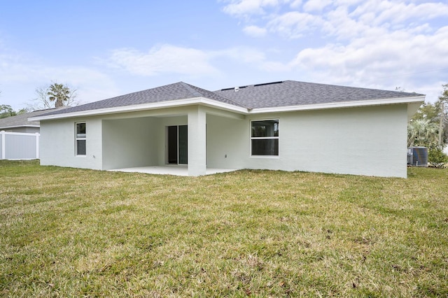 back of property with central AC, a yard, and a patio