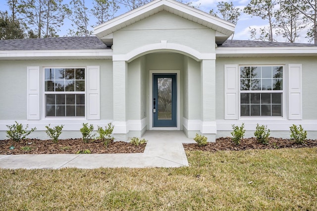 entrance to property featuring a yard