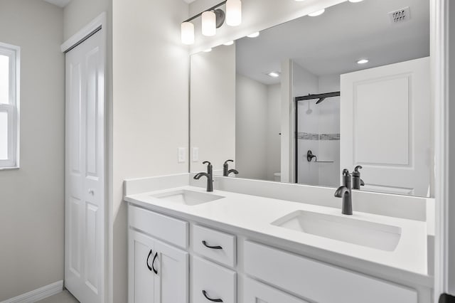 bathroom featuring vanity and a shower with shower door