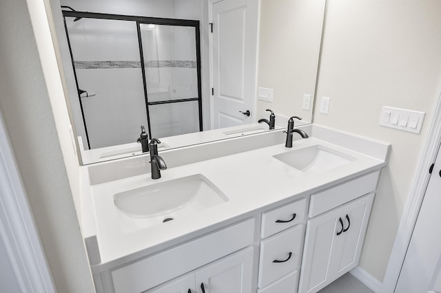 bathroom featuring vanity and a shower with shower door