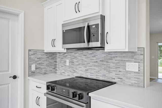 kitchen featuring white cabinetry, backsplash, and appliances with stainless steel finishes