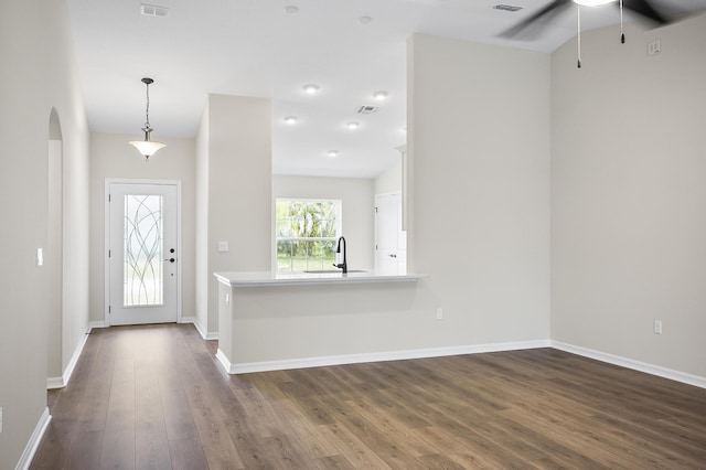 foyer entrance featuring ceiling fan, sink, and dark hardwood / wood-style flooring