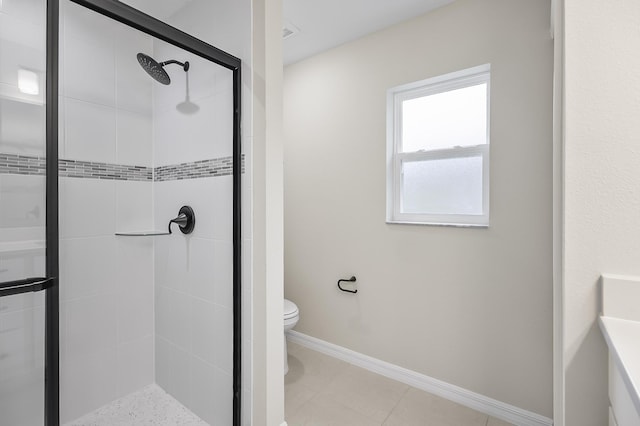 bathroom with tile patterned flooring, toilet, and walk in shower