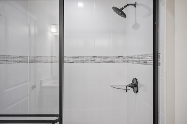 bathroom with a shower with door