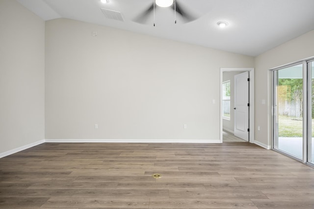 empty room featuring ceiling fan, lofted ceiling, and hardwood / wood-style floors