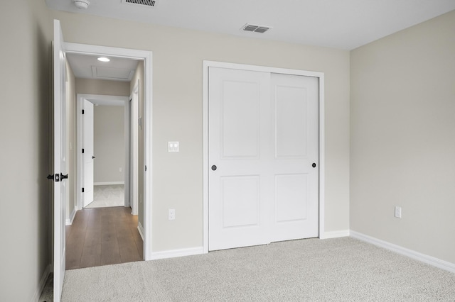 unfurnished bedroom featuring carpet flooring and a closet