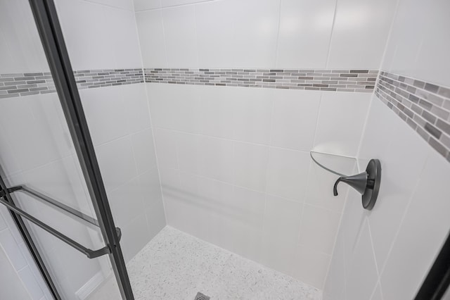 bathroom with tiled shower