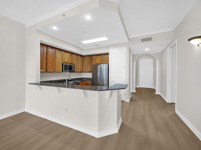 150 Pantano Cay Blvd Unit 2303, Saint Augustine, FL 32080 - kitchen featuring appliances with stainless steel finishes, a kitchen breakfast bar, brown cabinetry, and recessed lighting