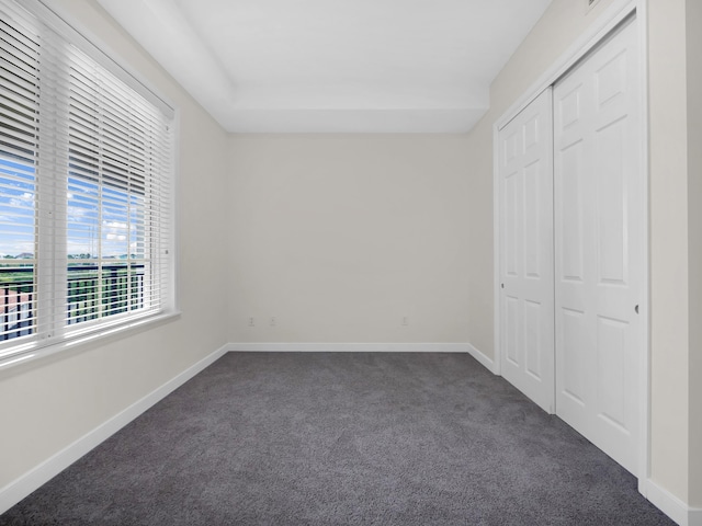 150 Pantano Cay Blvd Unit 2303, Saint Augustine, FL 32080 - unfurnished bedroom with dark carpet, baseboards, and a closet