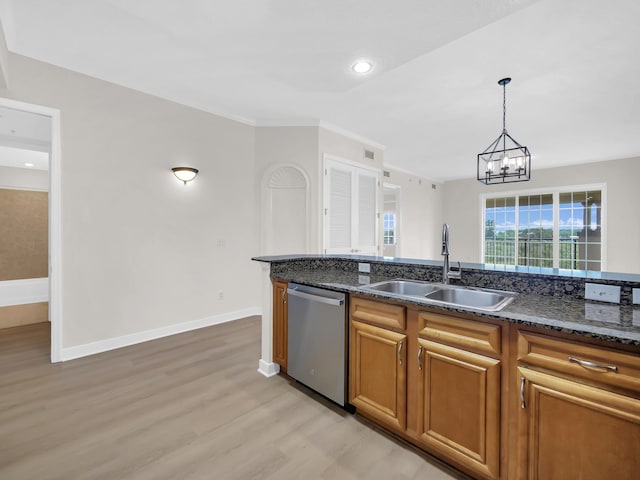 150 Pantano Cay Blvd Unit 2303, Saint Augustine, FL 32080 - kitchen with dishwasher, a sink, light wood finished floors, brown cabinets, and dark stone countertops