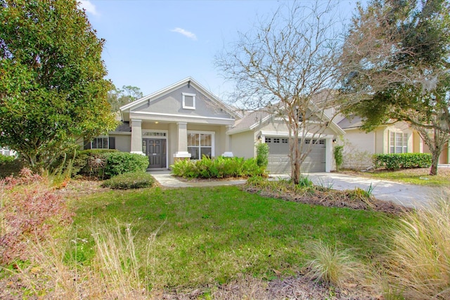 view of front of home featuring a garage and a front lawn