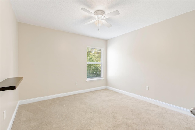 carpeted empty room featuring a textured ceiling and ceiling fan