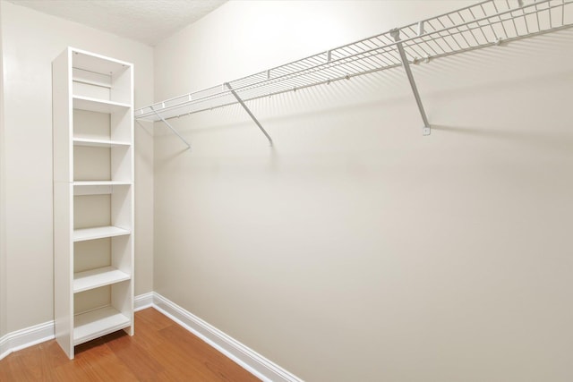 walk in closet featuring hardwood / wood-style floors