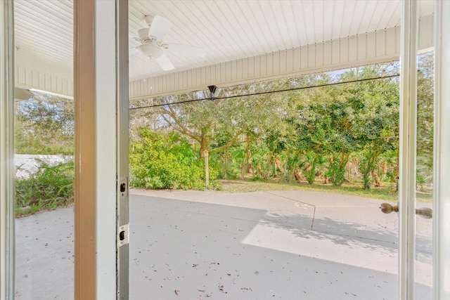 doorway with ceiling fan and a healthy amount of sunlight