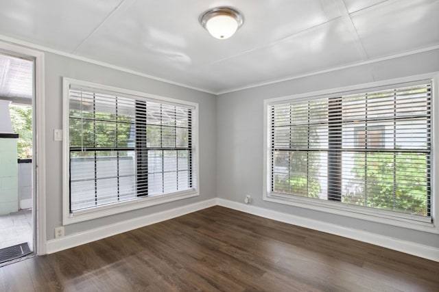 unfurnished room with dark hardwood / wood-style floors and ornamental molding