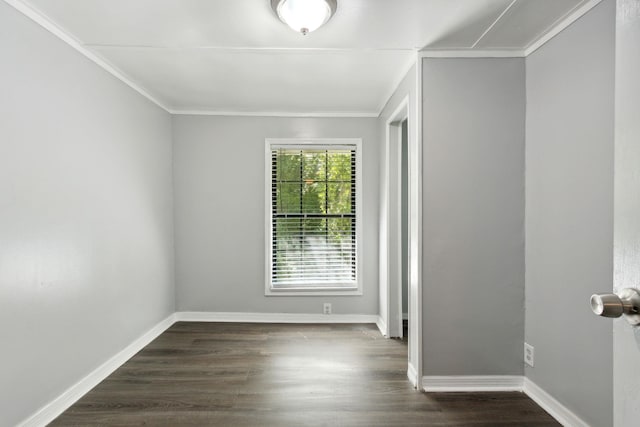 unfurnished room featuring ornamental molding and dark wood-type flooring