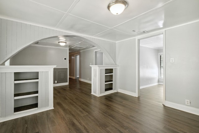 unfurnished living room featuring wood walls and dark hardwood / wood-style flooring