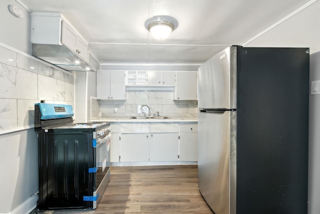 kitchen with stainless steel fridge, black stove, sink, hardwood / wood-style flooring, and white cabinets