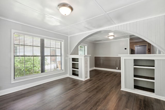 unfurnished living room with dark hardwood / wood-style flooring, crown molding, and wood walls